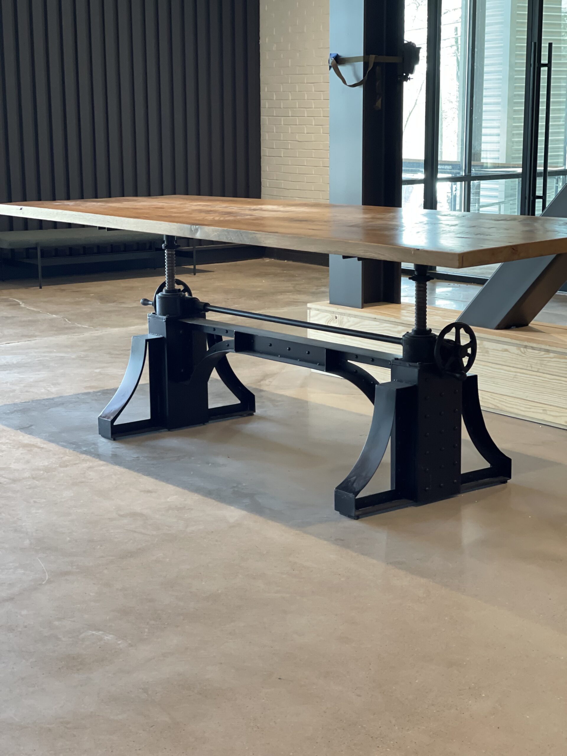 Community work table with rustic white oak top and industrial metal base