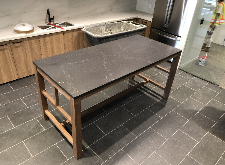 Community table with walnut base and stone top